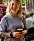 Smiling woman looking happy with the coffee she has made