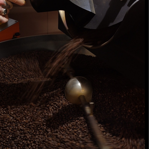 Coffee pouring out of a roaster